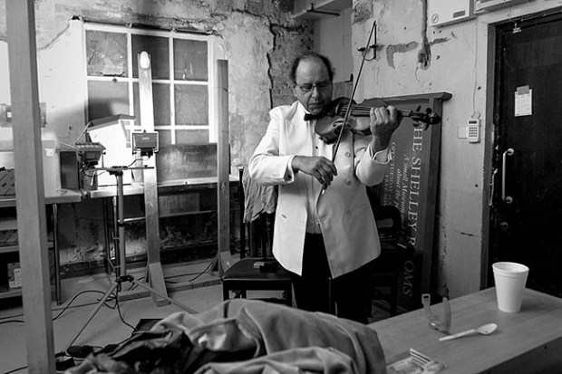 ©Neil Turner, September 2013. Violinist Jack Maguire warming up in his makeshift dressing room