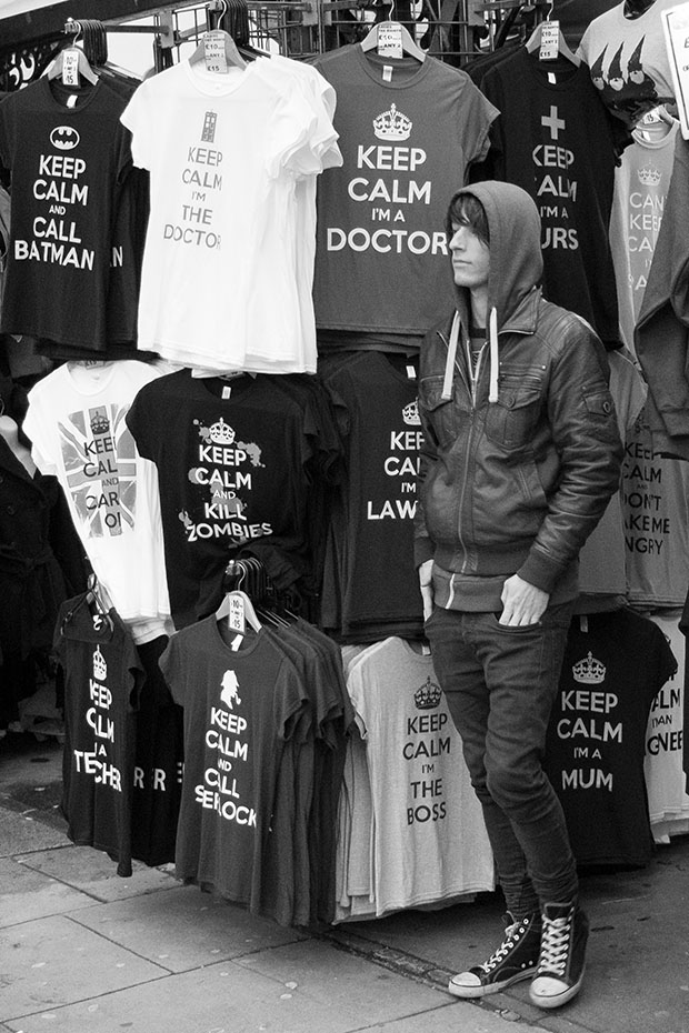 © Neil Turner January 2014. Cold and bored stall-holder selling keep calm t-shirts at Camden Market.