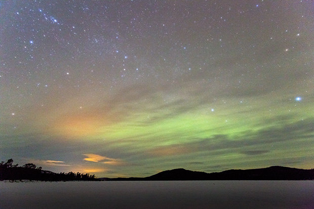 ©Neil Turner February 2014. Low level Aurora activity over a frozen lake, Inari County, Finland