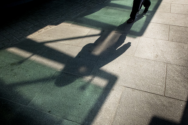 © Neil Turner, March 2014. Shadows on the pavement as a pedestrian passes along Tottenham Court Road.