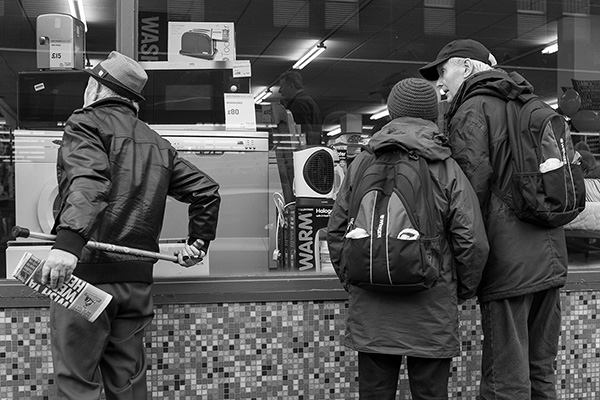 Pensioners window shopping in the Brtish Heart Foundation furniture and electrical good store in Winton.